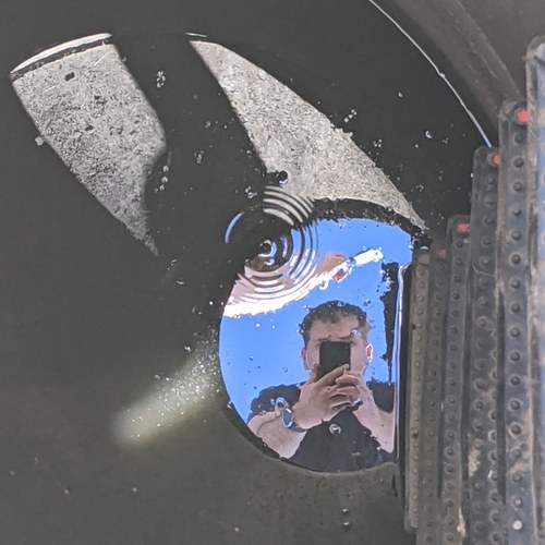 Brett's reflection, photographed from inside a large culvert pipe during a field visit